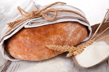 Fototapeta na wymiar Bread with flour on wooden table