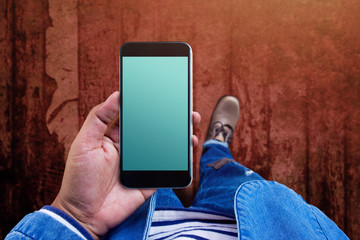 Blank smart phone screen on hand for mock up, Top view, present by casual urban guy, Mobile display as clipping path