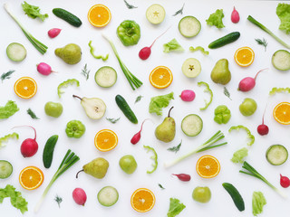 Vegetables and fruits on a white background. Pattern of vegetables and fruits. Abstract food background. Collage of food. Top view. Composition of pears, green peppers, cucumbers, green radish, green 