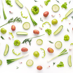 Vegetables and fruits on a white background. Pattern of vegetables and fruits. Food background.  Top view. Food collage of potato, green radish, pepper, lettuce, cucumber, green apples, onion.