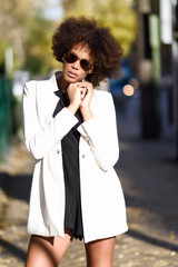 Young black woman with afro hairstyle with aviator sunglasses