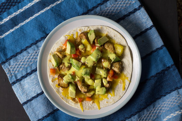 Open wrap with chicken, avocado and peppers - Top view