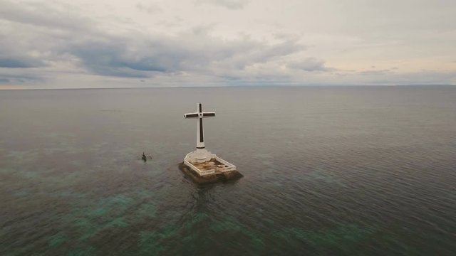 Aerial view Sunken Cemetery cross in Camiguin Island, Philippines. Large crucafix marking the underwater sunken cemetary of the coast of camiguin island near mindanao in the Philippines. Catholic