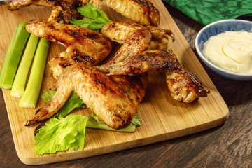 Chicken wings with celery sticks, white sauce, and copyspace