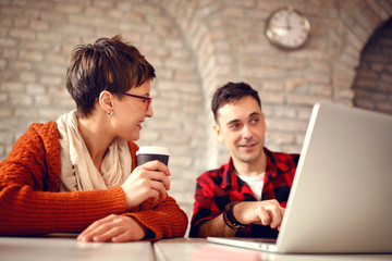 young designer couple working late at computer .