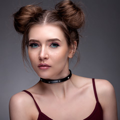 Portrait of a beautiful girl with a beautiful make-up on a gray background.