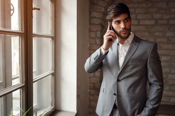 success businessman in suit with smartphone.