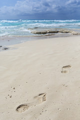 Footsteps on the beach. Sunny summer day by the sea shore.