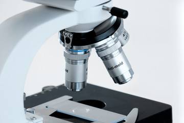 Laboratory lens of Microscope Isolated on bokeh/blur light blue background.