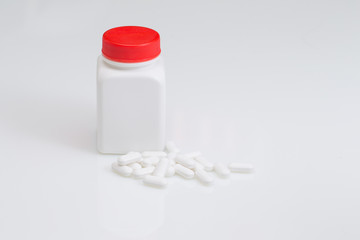 Paracetamol Tablets and Bottle on white table