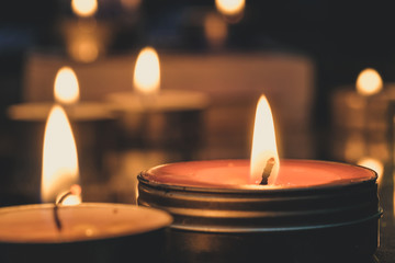 Prayer and hope concept - Retro candle light in the Church. Vintage image.