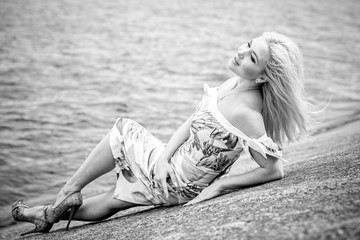 Beautiful woman at the resort resting on the waterfront. Romantic style in clothes and image