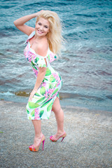 Beautiful woman at the resort resting on the waterfront. Romantic style in clothes and image