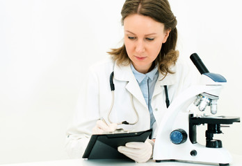 Doctor writing results of the test in laboratory.