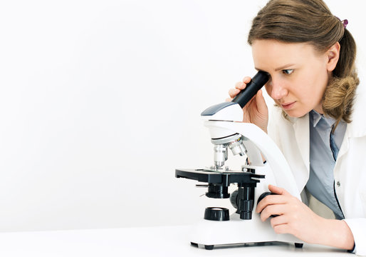 Scientist using microscope in laboratory. Space for text.
