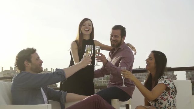 Group of friends clinking champagne glasses outdoors