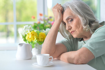 Beautiful old woman is sad 