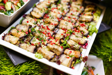 Eggplant rolls with walnuts. Delicious fried aubergines with nuts, herbs and pomegranate seeds. Dish of Georgian cuisine.
