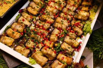 Eggplant rolls with walnuts. Delicious fried aubergines with nuts, herbs and pomegranate seeds. Dish of Georgian cuisine.