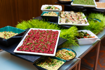 people group catering buffet food indoor in luxury restaurant with meat colorful fruits and vegetables