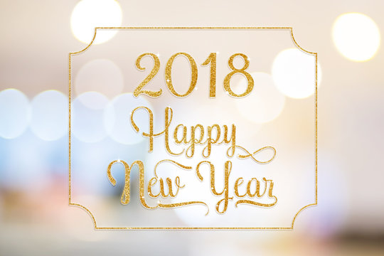 Happy New year 2018 gold sparkling glitter word with golden frame at abstract blurred bokeh light background, Holiday concept