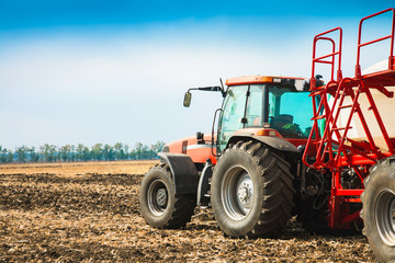 Tractor with tanks in the field. Agricultural machinery and farming.