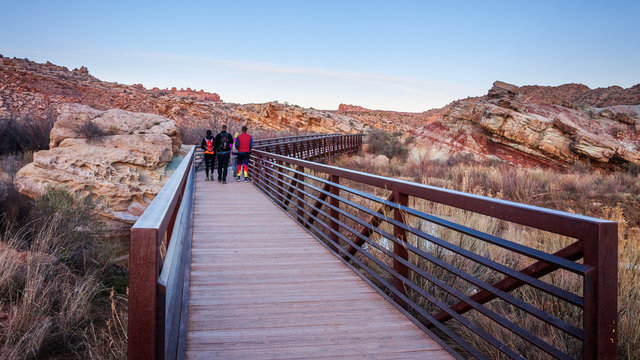People waking on one of the bridges on the trail towards the Delicate Arch in Arches National Park.