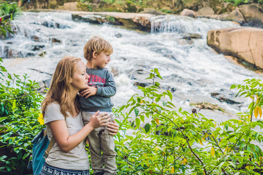 Mother and son on the background of Beautiful Camly waterfall In Da Lat city
