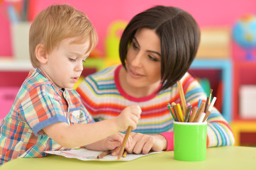 Fototapeta premium Mother with her son draw with pencils