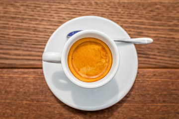 Coffee cup on wooden table. Top view