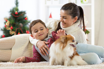 Family with dog at christmas tree