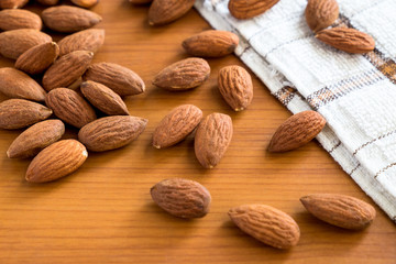 Almonds seed nut on the wooden table, healthy almond nuts with nature tasty.
