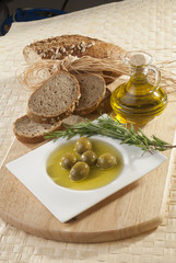Olives with olive oil and bread with rosemary 