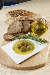 Olives with olive oil and bread with rosemary 