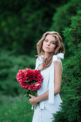 .Girl in white beautiful dress with flowers