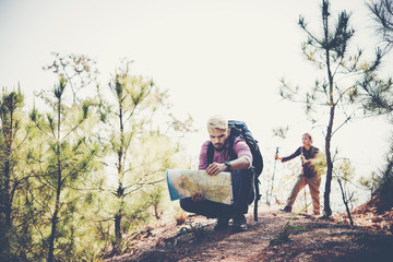 Portrait of adventure young man hiking with map on mountain