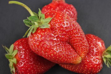 Large berry of strawberry on a black background