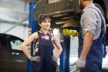 Trainee of car-service mechanic listening to his recommendations