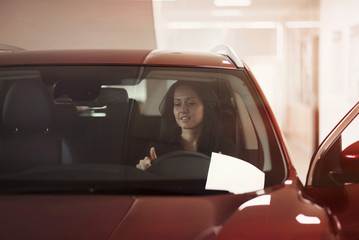 Fototapeta premium girl admires interior of car