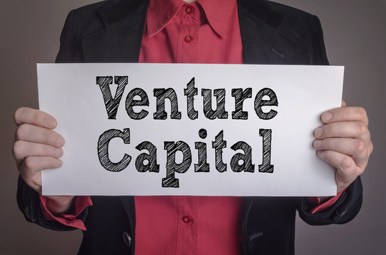 Venture capital message on white card hold by businessman