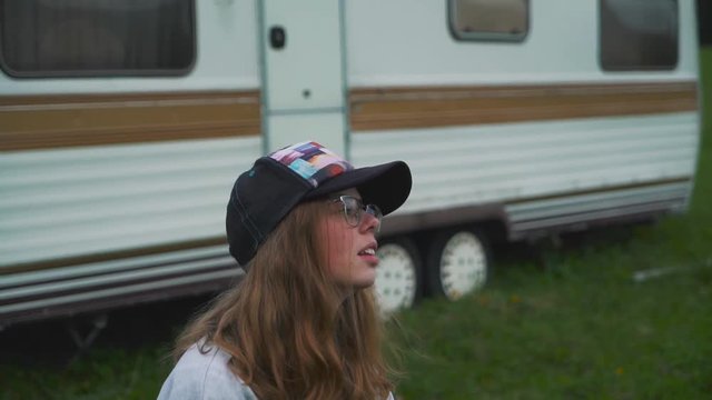 Hippie girl near a trailer.