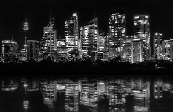 Sydney Waterfront at night seen from Farm Cove, with reflections in bay's water