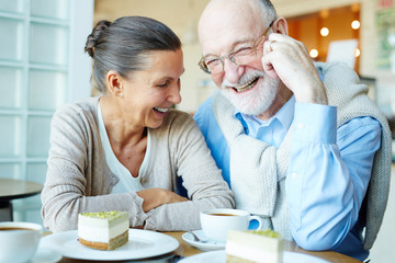 Joyful spouses having fun in cafe at leisure