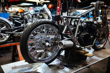 Fototapeta na wymiar Background image of big disassembled motorcycle in workshop