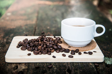Cup of coffee with bean on the wooden background