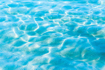 Sand under clear water ripple background, blue coloration use for background