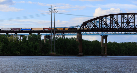 Railroad and car bridges over Hudson River at Schodack State Park. Freight train passing through.