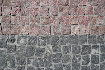 Rubble gray and brown square stones paved road