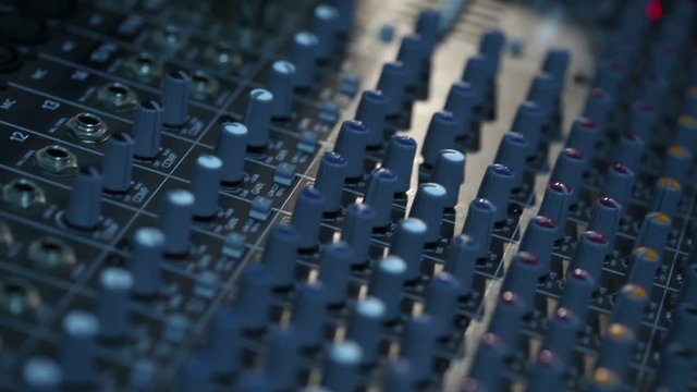 Professional audio console in a concert, sound mixer console during a concert, audio Mixer, control engineer, selective focus, audio mixer, shallow depth of field