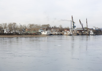 Harbor cranes at cargo port on the Siberia river.